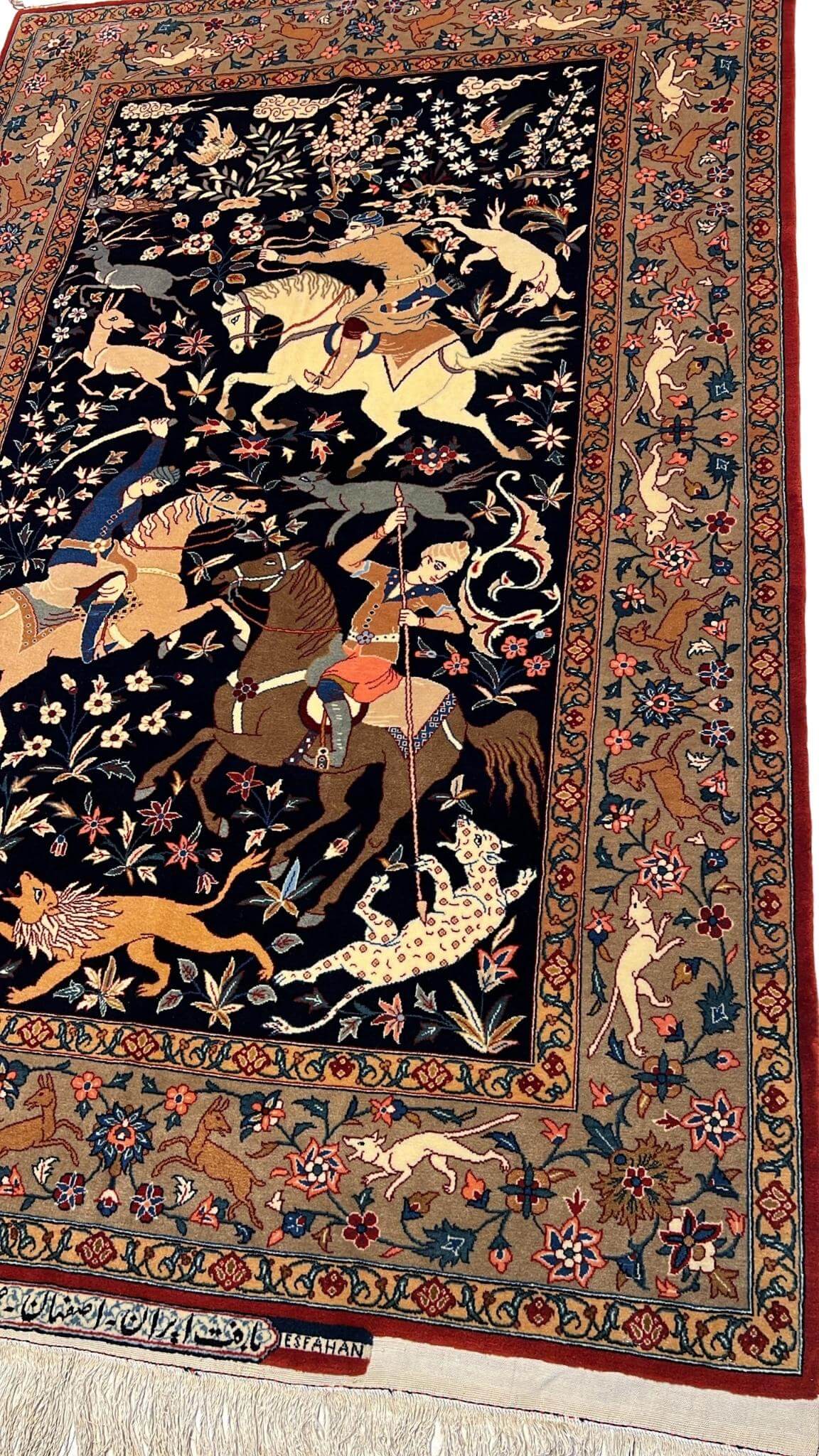 Detail shot of the hand-woven Seirafian rug’s hunting scene, capturing the fine detail and artistry of Persian craftsmanship.